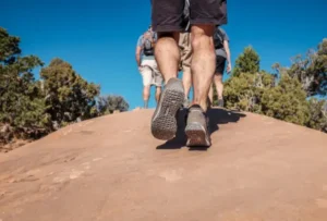 people's feet on a dirt path